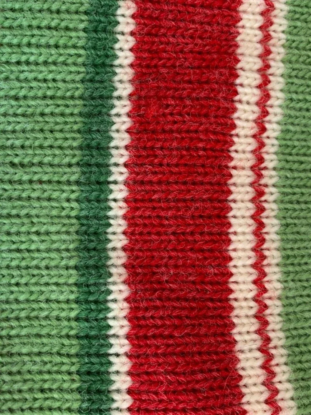 Vintage style knit Christmas stocking in red green and ivory stripe pattern